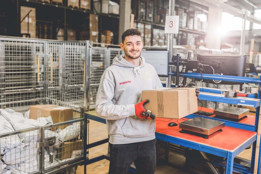 Employee at exporto with parcel in his hands in the Konstanz warehouse